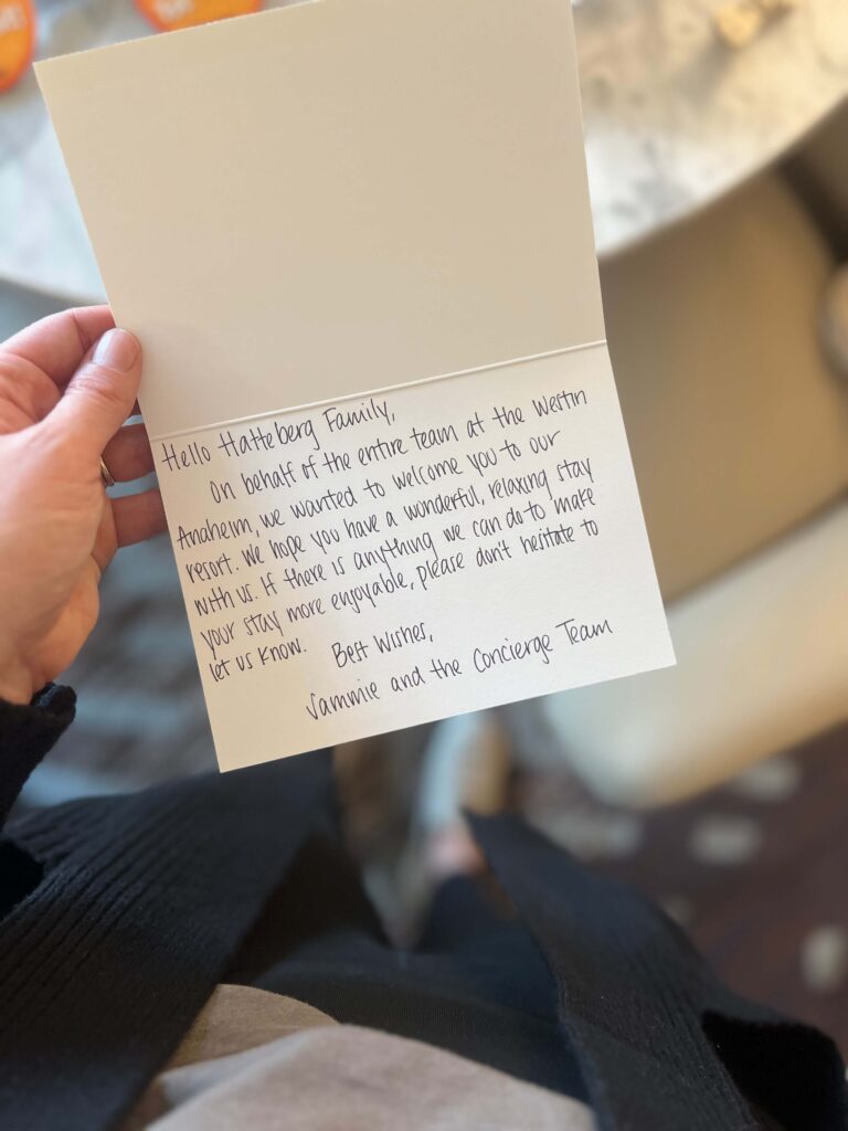 woman holding card from hotel hospitality team