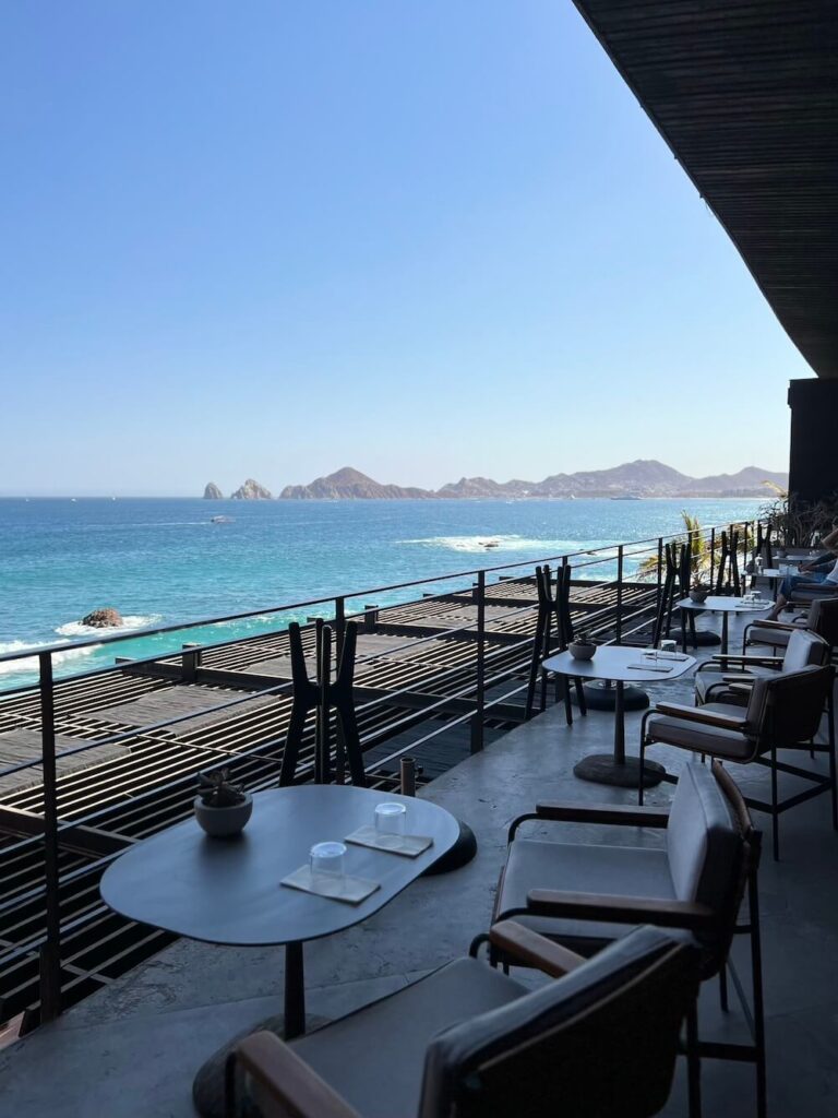 stunning view of beach and mountains in the distance from an outdoor restaurant