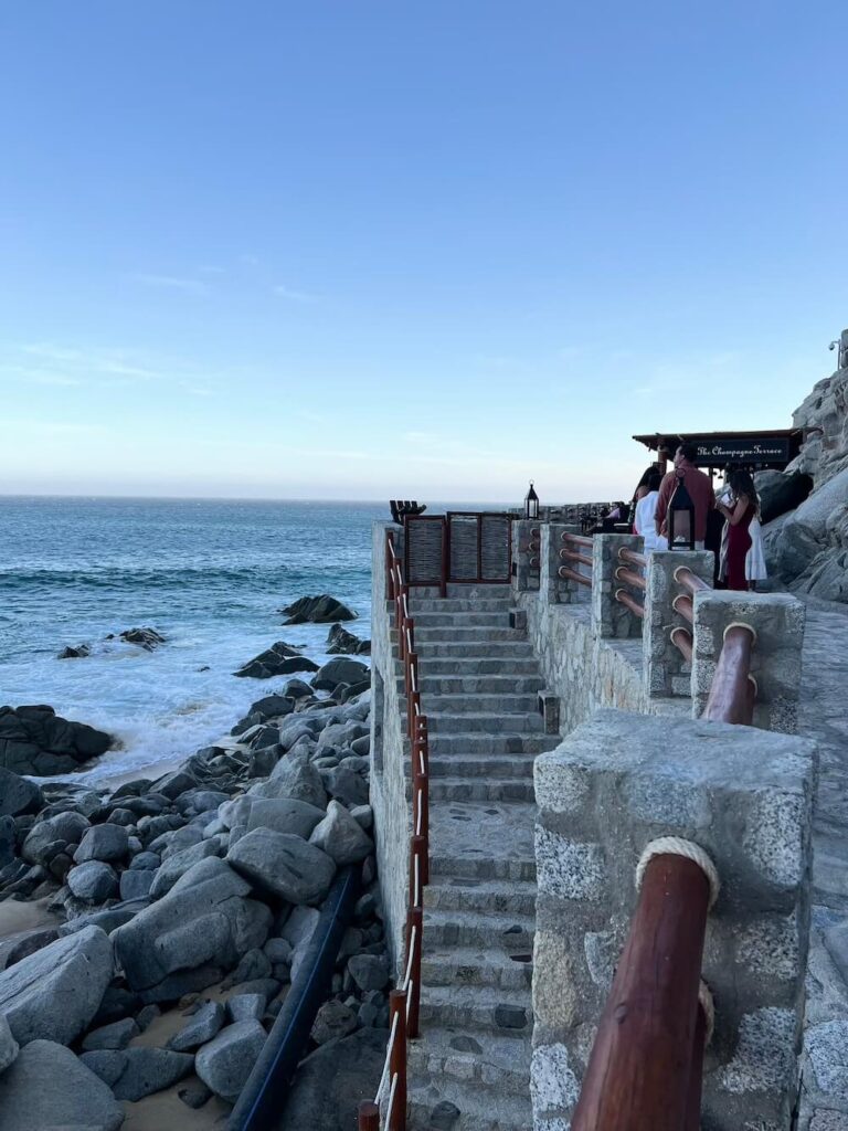 stone steps outside a building with the beach in the background