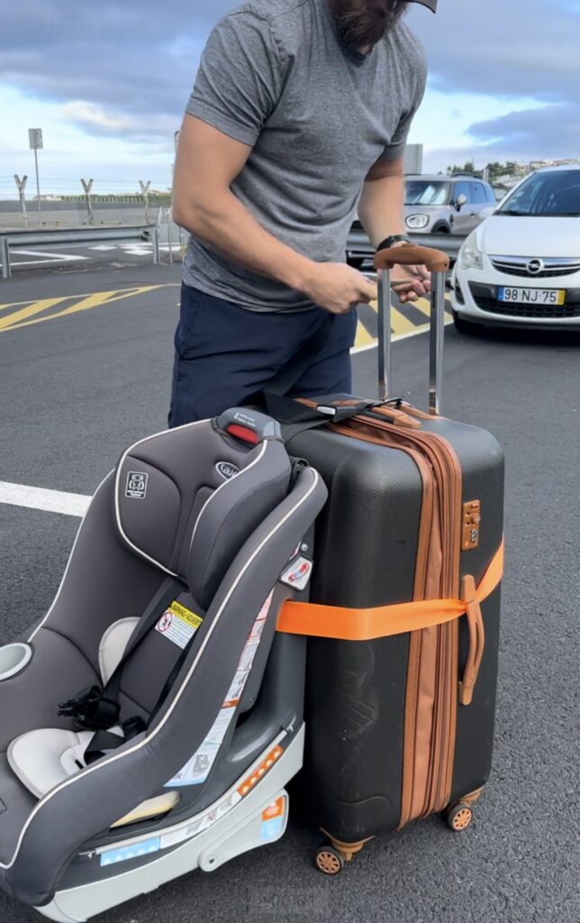 Dad using car seat travel belt for a car seat