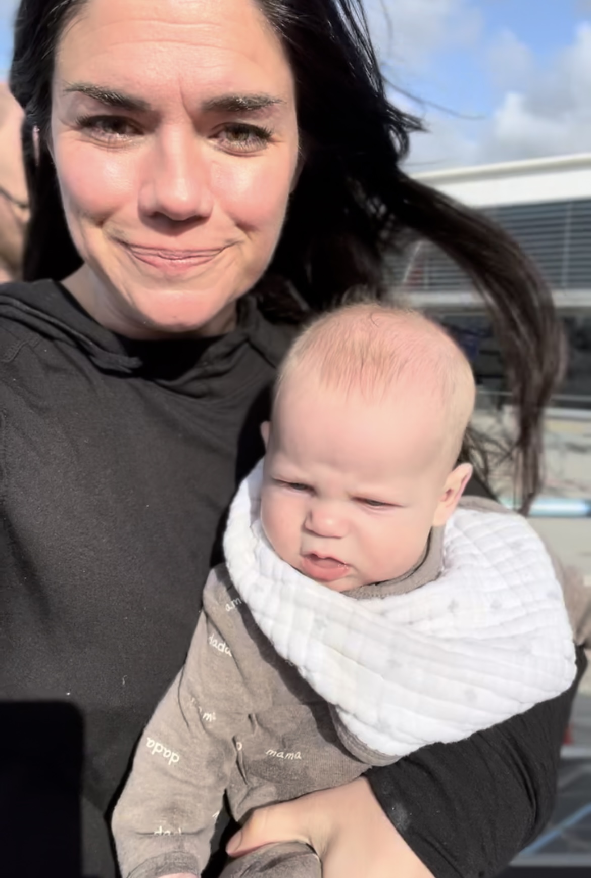 mom with baby with clip on burp cloth