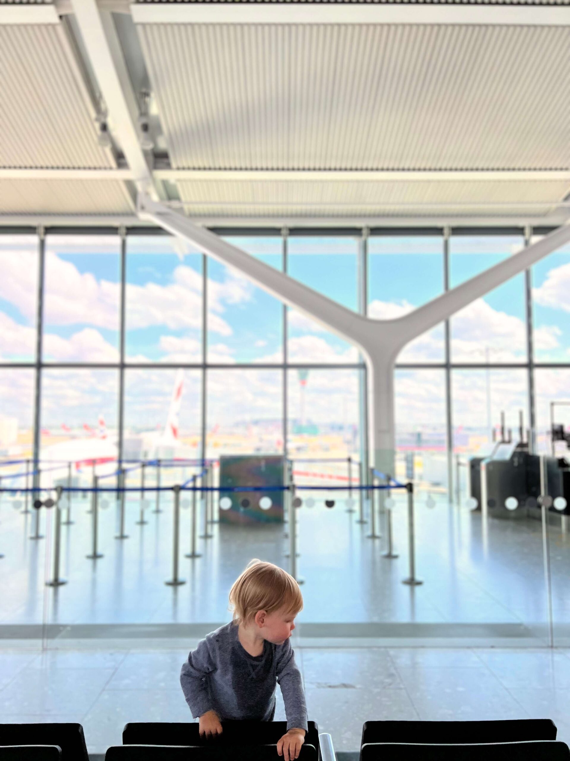 little boy playing in an airport