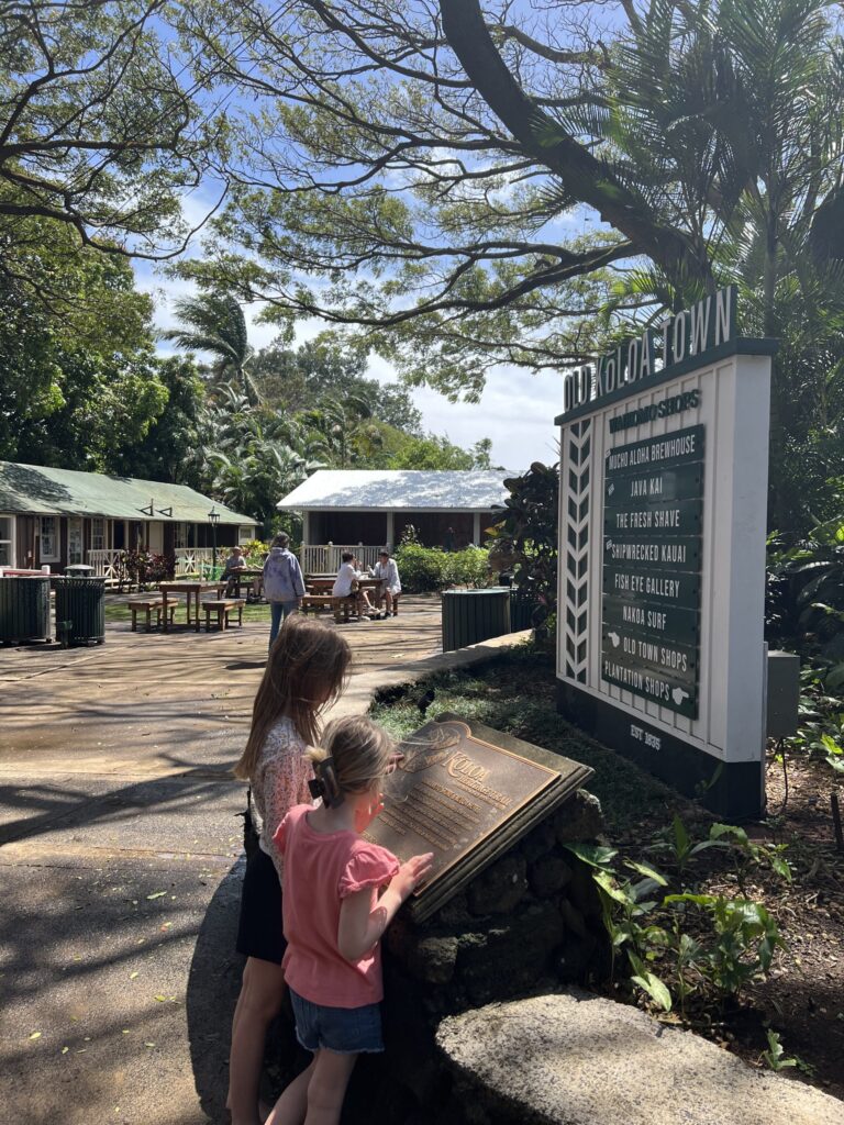 little girls looking at a sign at Old Koloa Town in Kauai