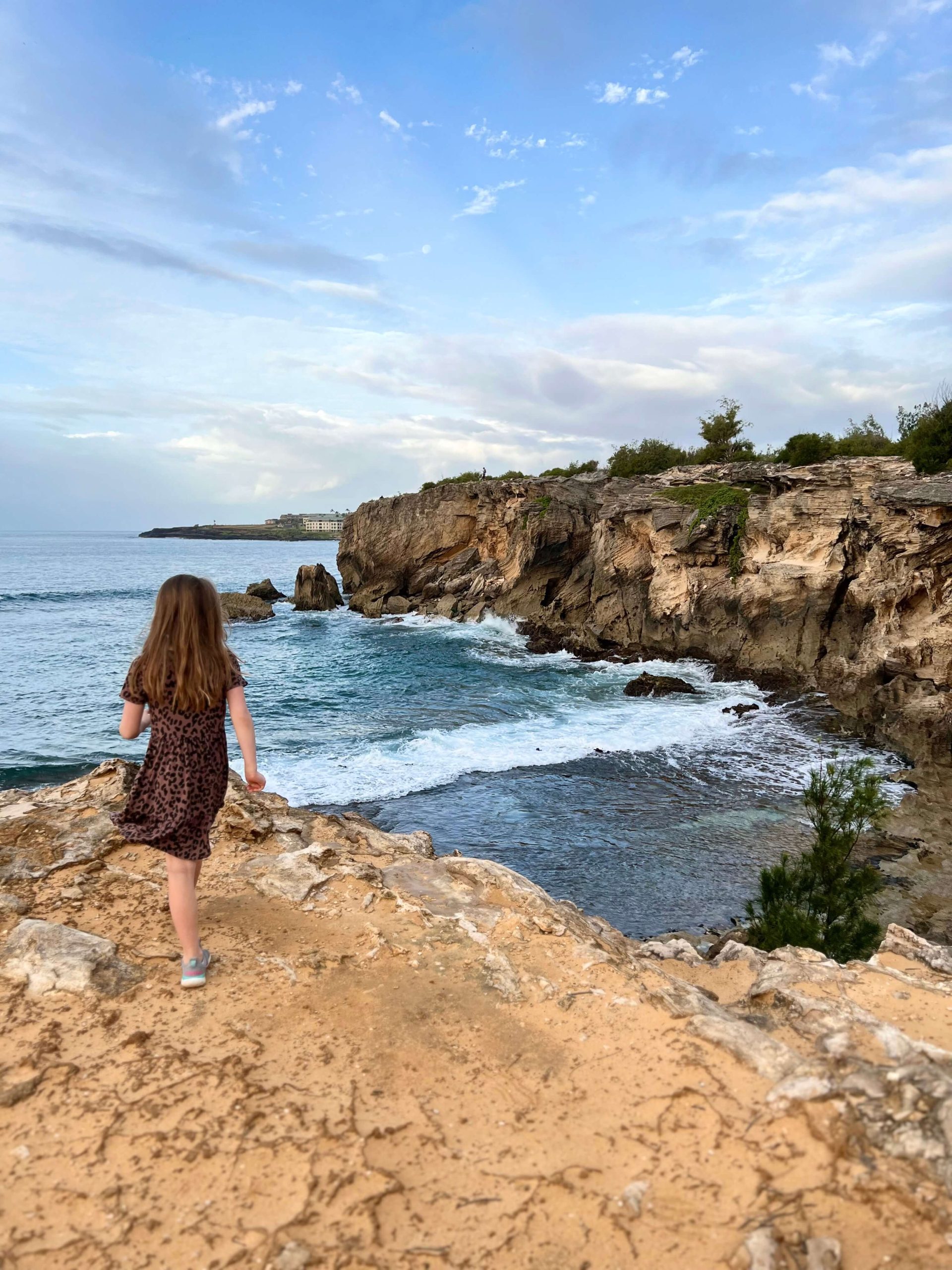 little girl standing on the cliff at kauai